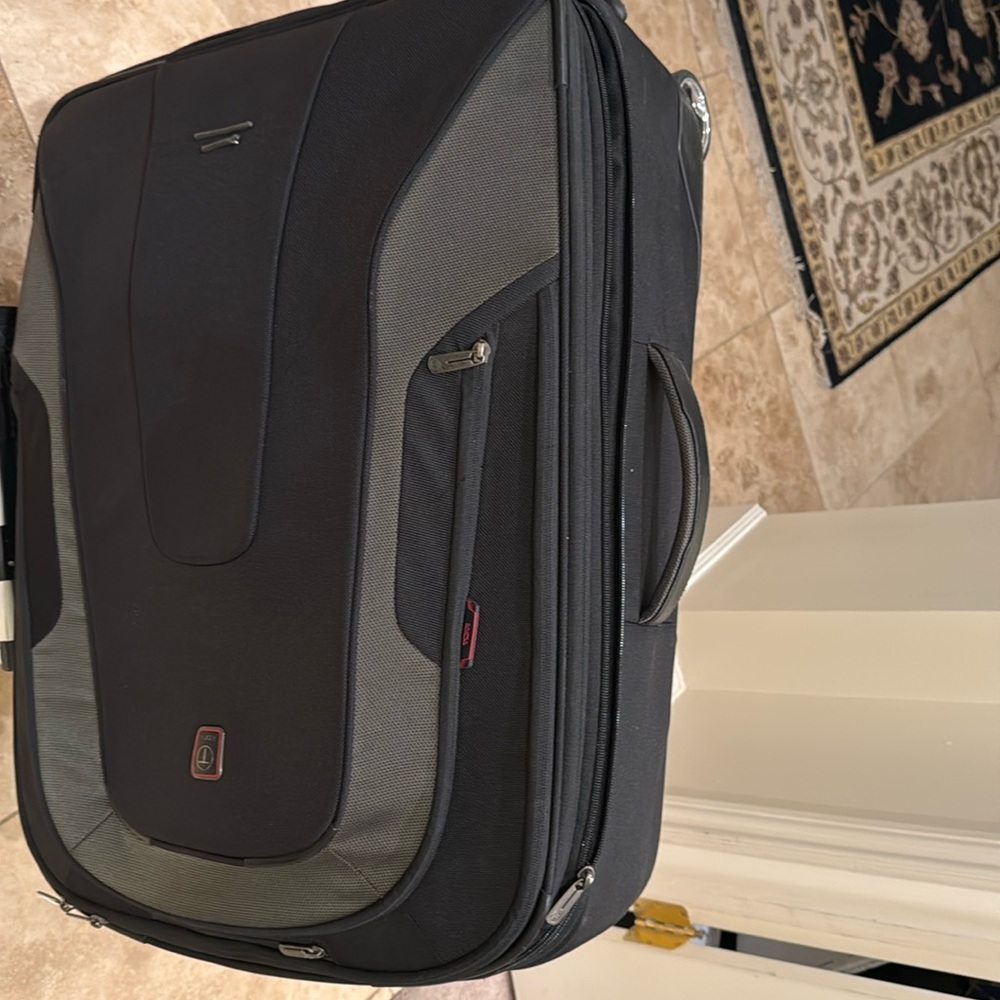 Tumi soft checked bag. Two wheels. Black color Gently used. 28”